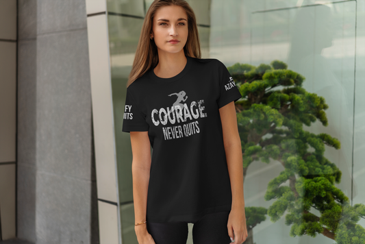 Woman wearing a black t-shirt with 'Courage Never Quits' text, standing outdoors.