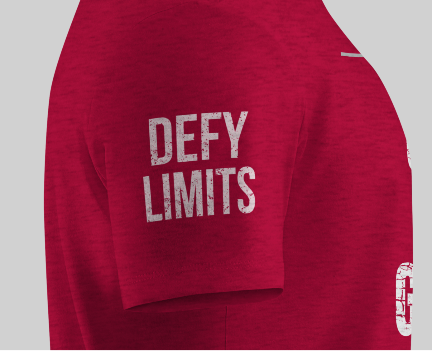 Grit and Grind red t-shirt with 'DEFY LIMITS' text on sleeve with a gray background