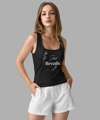 Woman wearing a black tank top with 'Just Breathe' text and white shorts on a gray background