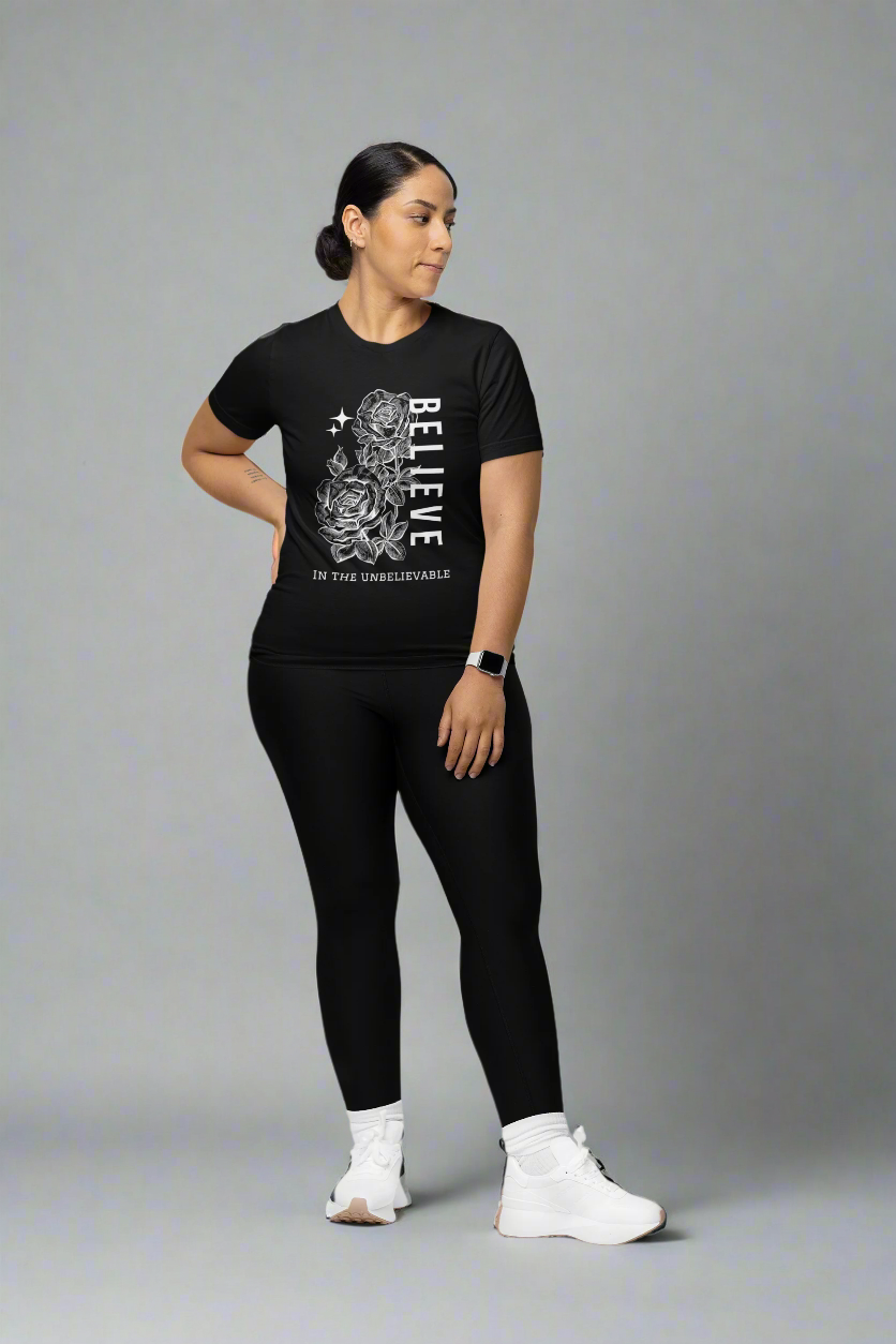 Woman wearing the Believe in the Unbelievable T-shirt in a studio setting, showcasing a motivational design that inspires confidence and limitless potential.