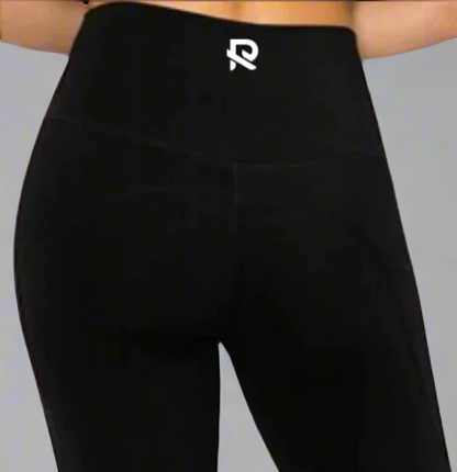 Close-up back view of black leggings featuring an "R" logo centered on the waistband. Designed for a sleek fit and comfortable support, perfect for workouts and everyday wear.