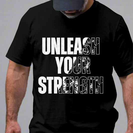 Cropped image of a bearded man looking down while wearing a black T-shirt featuring "Unleash Your Strength" in bold black and white lettering. The design emphasizes power and resilience.