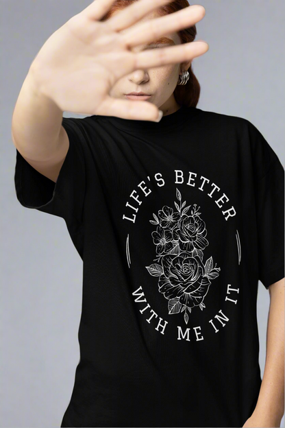 Woman covering her face in a studio while wearing the Life Is Better With Me In It T-shirt, highlighting its uplifting message and relaxed fit.