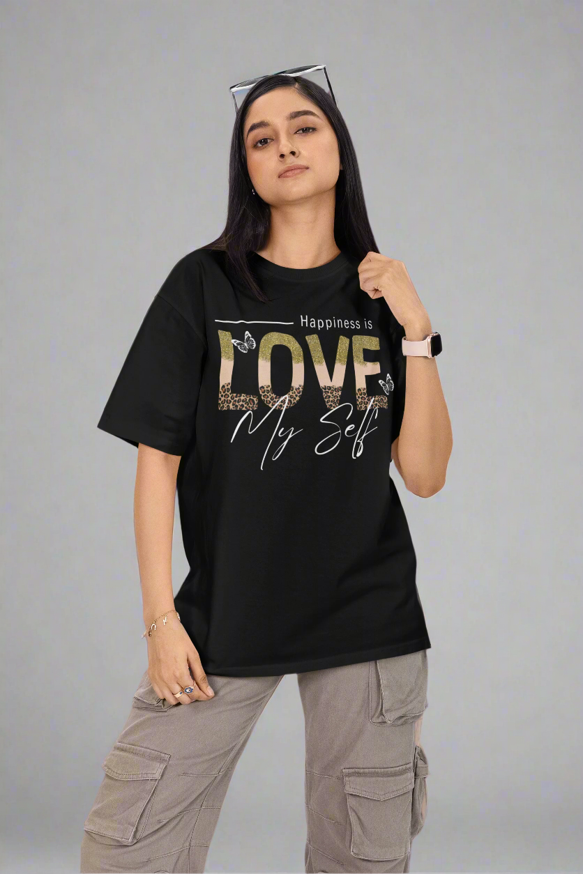 Woman standing against a grey backdrop wearing a  black Love Myself round-neck T-shirt. This soft and stylish tee promotes self-love and confidence, perfect for casual and active wear.
