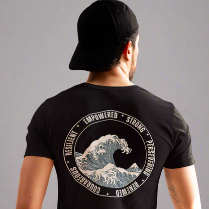 Back view of a man wearing the Wave of Strength T-shirt, featuring a wave design surrounded by the words "Resilient, Empowered, Strong, Renewed, and Courageous," symbolizing inner strength and perseverance.